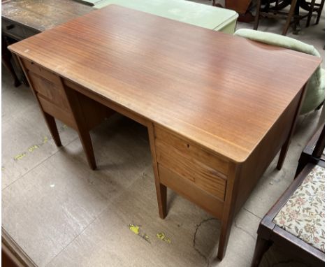 A mid 20th century teak desk with a rectangular top above two banks of drawers on square tapering legs