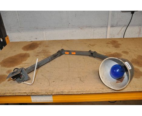 A VINTAGE ARTICULATED INDUSTRIAL WORKSHOP LAMP with 4 angle adjustments, a 14cm diameter shade (untested due to bare cable)