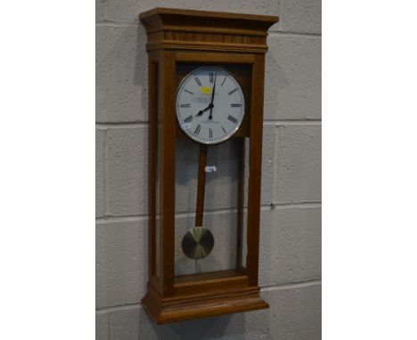 A MODERN GOLDEN OAK LONDON CLOCK COMPANY WALL CLOCK, height 70cm, along with a mahogany glazed corner cupboard, a teak circul