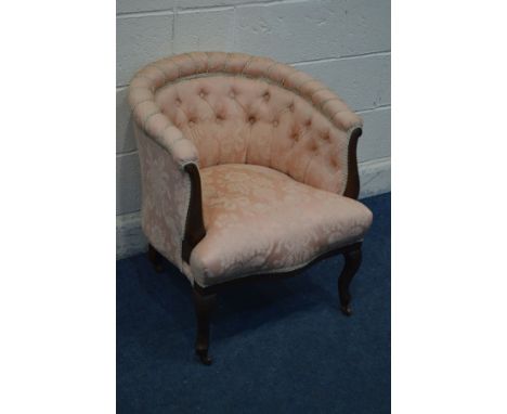 AN EDWARDIAN MAHOGANY TUB CHAIR with pink upholstery, on ceramic casters
