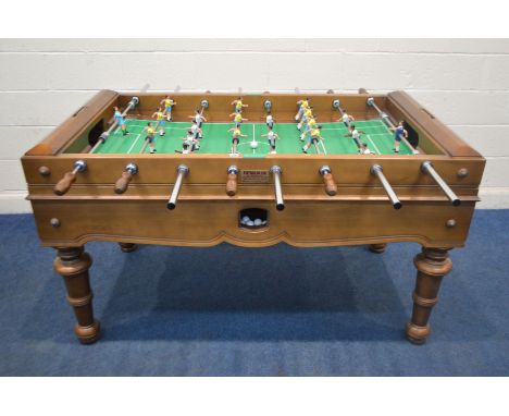 A FUTBOLIN UK MAHOGANY TABLE FOOTBALL GAME, with painted metal players, playing in white and yellow, sloping pitch, a hinged 