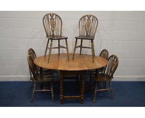 AN EARLY 20TH CENTURY OAK BARLEY TWIST GATE LEG TABLE, open length 149cm x closed length 56cm x depth 107cm x height 74cm and