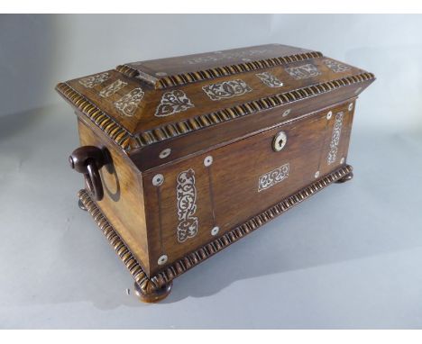 A Regency rosewood mother of pearl tea caddy the casket shape with repeating button roundel edging to top and mother of pearl