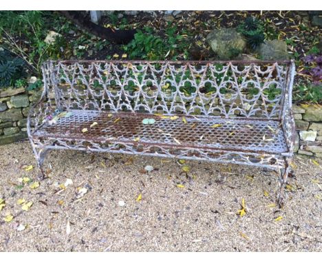 A distressed painted C1900 wrought iron fret garden bench with broken front support AF