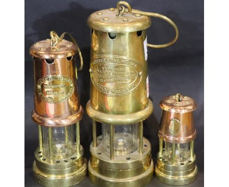 Three reproduction copper and brass colliery lamps, tallest H: 21 cm. P&amp;P Group 3 (£25+VAT for the first lot and £5+VAT f