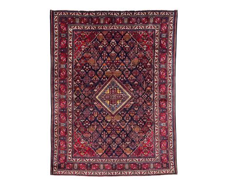 Persian Meimeh indigo ground rug, the central medallion within a field of small floral lozenge motifs, the guarded border wit