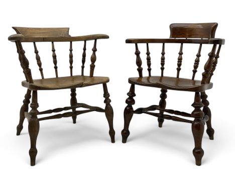 Late 19th century elm smoker’s bow armchair, curved top rails over turned spindle backs, shaped seats, raised on turned legs 