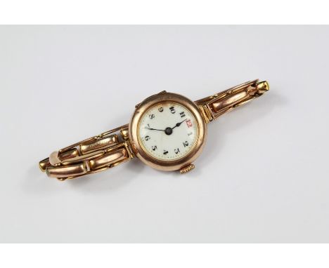 A Lady's 9ct Gold Wrist Watch. The watch having a white enamel face with numeric dial on gold-plated elasticated bracelet.