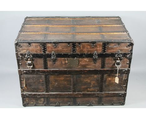 An Ebonised Travelling Trunk. The trunk having metal bandings and leather handles to sides, approx 92 x 56 x 65 cms.&nbsp;