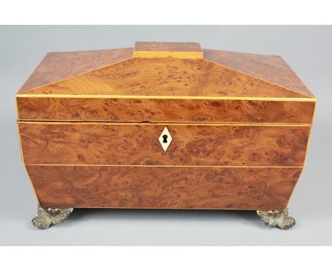 A Late George III Yew Wood Tea Caddy. The tea caddy of sarcophagus form having decorative box stringing, with a fitted foil-l