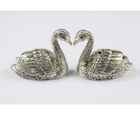 A Pair of Sterling Silver Condiments. The condiments in the form of swans with ruby eyes, approx 50 x 45 mm, approx 92 gms.