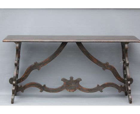 An Italian Ebonised Console Table. The table having elaborate carved stretchers and side support, approx 170 x 43 x 83 cms. N