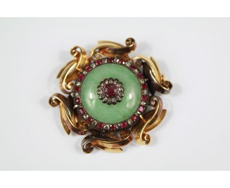 A Late 19th Century Chinese 18ct Yellow Gold Chinese Jade, Ruby and Diamond Brooch. The apple-green jade disc set with a cent