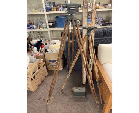 Two Theodolites on tripod stands and two vintage ranging poles.