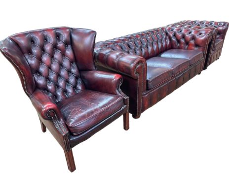 Three piece button backed ox blood leather three seater Chesterfield suite.