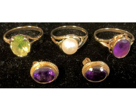 A 9ct gold amethyst ring, size N/O, 2.3g; a pair of 9ct gold amethyst earrings, 2g; a 9ct gold citrine ring, size L, 2.3g; a 