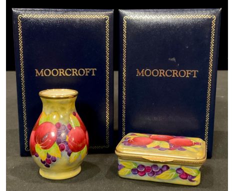 A Moorcroft miniature Pomegranate pattern enamel baluster vase, 6cm, boxed; a Pomegranate pattern enamel patch box and cover,