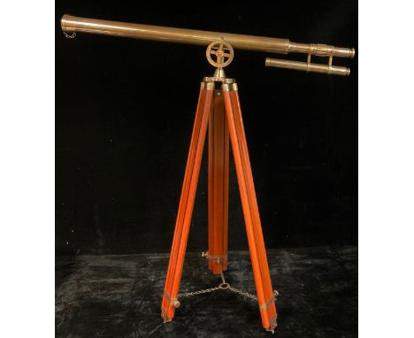 A reproduction brass telescope on tripod stand, the telescope 96cm long 