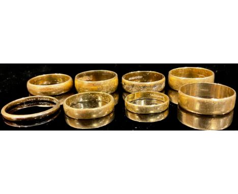 A 9ct gold wedding band, size Q/R, marked 375, other 9ct gold bands, 23.5g (8) 