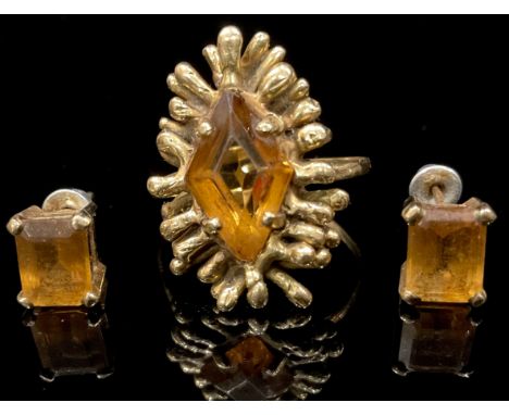 An unmarked gold ring, of modernist design, set with a faceted topaz, size R, 7.2g; an accompanying pair of topaz earrings, a