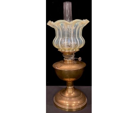 An oil lamp, fluted uranium vaseline glass shade, clear glass chimney, 52.5cm overall 