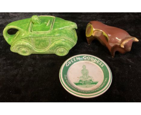 A Sadler Art Deco racing car teapot; a lustre bull; a Green Goddess advertising dish (3) 