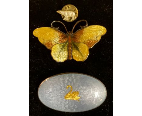 A Norwegian silver and enamel butterfly brooch, marked sterling, 5cm wide; another sterling silver oval engine turned enamel 