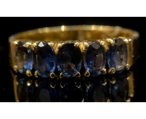 An 18k gold, five stone tanzanite ring, size P, 3.2g 