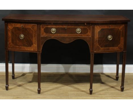 A George III Revival mahogany bowfront serving table or sideboard, oversailing top above a central frieze drawer, flanked by 