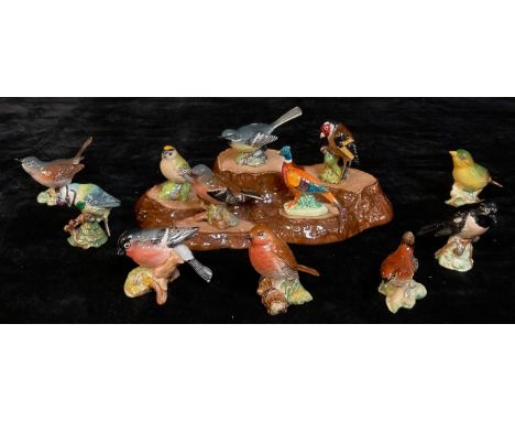 A collection of Beswick bird models with stand, including Greenfinch, Stonechat, Grey Wagtail, Goldfinch, Whitethroat, Robin,