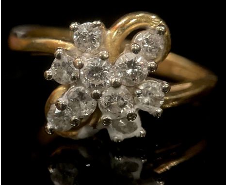 An 18ct gold ten stone diamond flower head cluster ring, size N, marked 750, 4.7g 