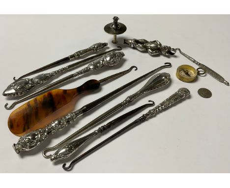 An Elizabeth II silver novelty bottle pourer, as a pheasant; various silver button hooks; a compass; etc 