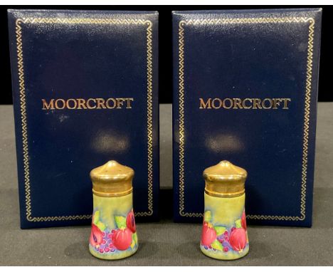 A pair Moorcroft miniature Pomegranate pattern enamel salt and pepper pots, 4.5cm, each boxed (2) 