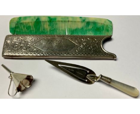 A silver comb case, Birmingham 1903; a silver perfume funnel, marked 925; a silver and mother of pearl bookmark, as a trowel,