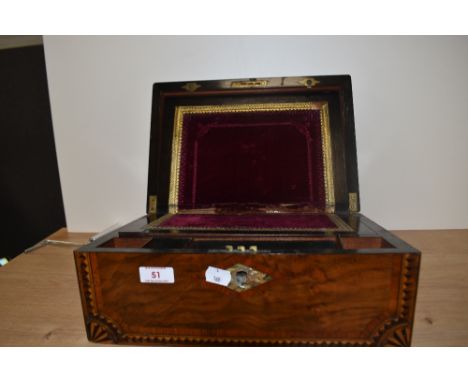 A Victorian walnut and geometric inlaid writing slope, having a mother of pearl lozenge to the lid, opening out to a red clot