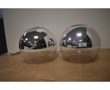 A pair of contemporary glass spherical light shades with chrome finish, measuring 21cm tall
