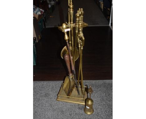 A selection of vintage brass fireside companion set items.