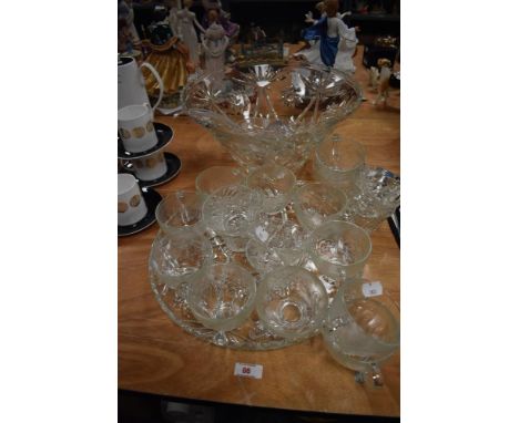 A cut glass punch bowl set with ladle and cups