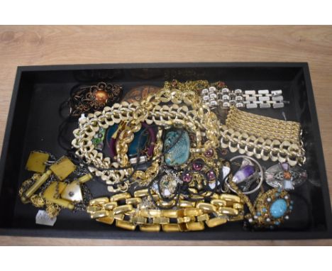 An assorted collection of costume jewellery, including a Celtic style pendant on chain, enamelled pendants, and gold coloured