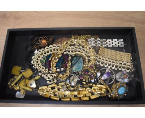 An assorted collection of costume jewellery, including a Celtic style pendant on chain, enamelled pendants, and gold coloured