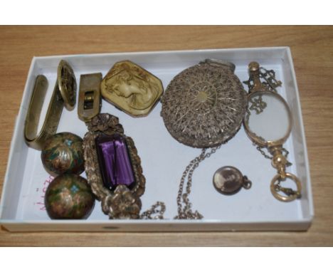 An assorted collection of white metal jewellery, including a filigree locket on chain, a Cloisonne brooch, a yellow metal cam