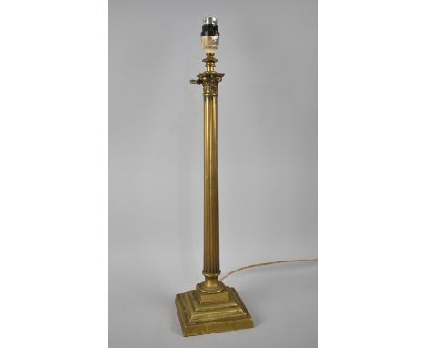 An Edwardian Rise and Fall Brass Table Lamp in the Form of a Ribbed Corinthian Column on Stepped Square Base 