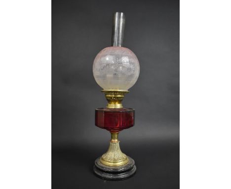 A Victorian Oil Lamp with Cranberry Glass Reservoir Supported on Brass Support complete with Frosted Cranberry Glass Globular