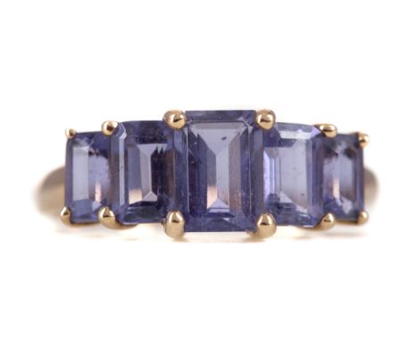 TANZANITE FIVE STONE RING, set with step cut stones, in nine carat gold, size P, 2.4g