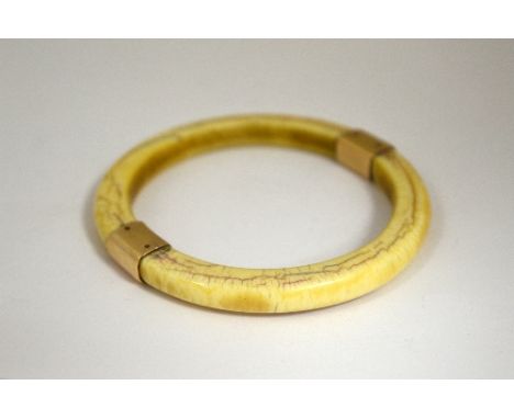 AN IVORY BANGLE, with rose gold coloured sides