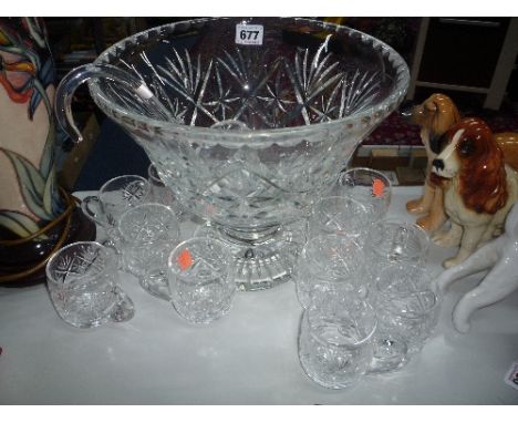 A CUT GLASS PUNCH BOWL, twelve glasses and ladle (14)