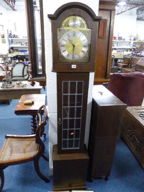AN OAK GRANDMOTHER CLOCK, with lead glazed door, face marked Made in