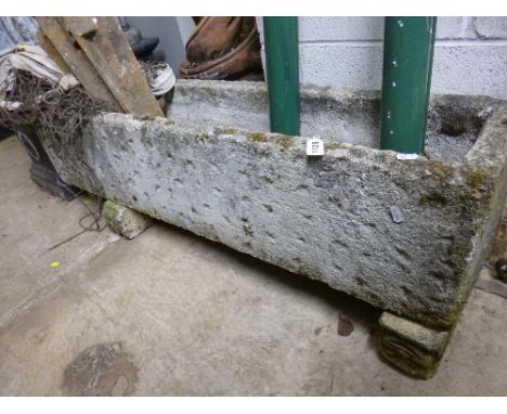 A LARGE COMPOSITE PLANTER, on two feet