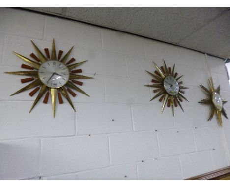 A PAIR OF RECENT 'METAMEC' BATTERY OPERATED SUNBURST WALL CLOCKS, and a similar 'Electora' clock (3)