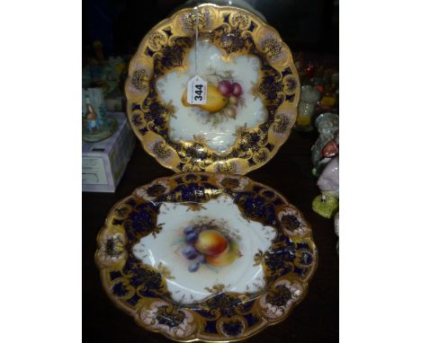 TWO ROYAL WORCESTER CABINET PLATES, by R. Sebright & G. Cole, transfer printed with fruit within a raised gilded blue border 